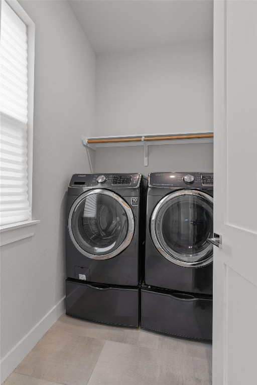 5002 Pecan Springs Road, Unit 1 Austin, TX 78723 - Photo 23 of 38 Laundry room with baseboards and washer and clothes dryer