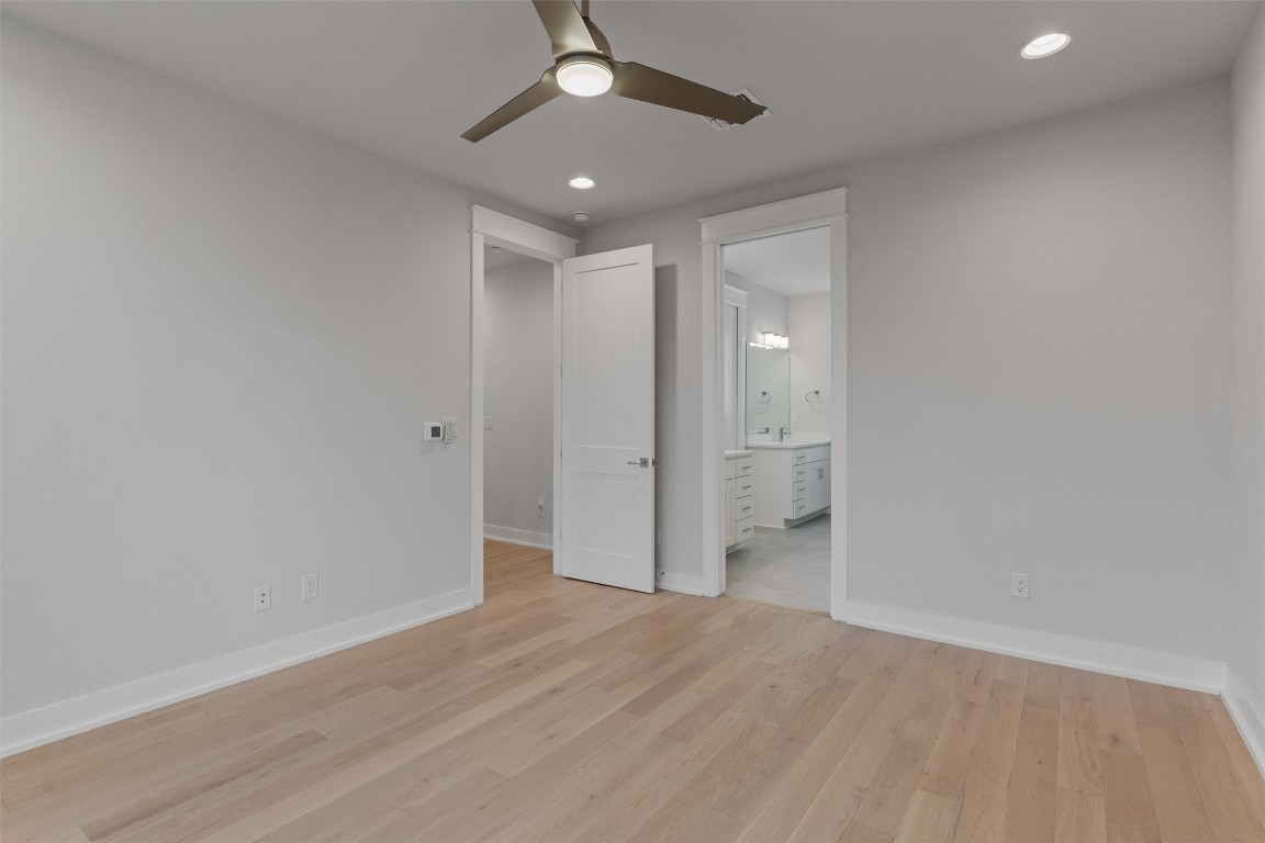 5002 Pecan Springs Road, Unit 1 Austin, TX 78723 - Photo 25 of 38 Unfurnished bedroom with ceiling fan, light wood-type flooring, connected bathroom, and recessed lighting
