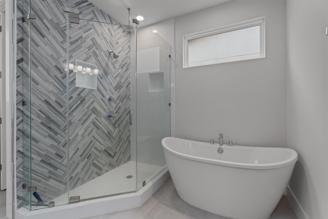 5002 Pecan Springs Road, Unit 1 Austin, TX 78723 - Photo 27 of 38 Full bath featuring a freestanding tub, a shower stall, and tile patterned floors