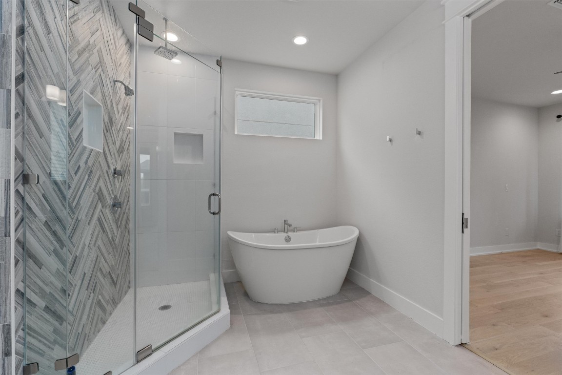 5002 Pecan Springs Road, Unit 1 Austin, TX 78723 - Photo 28 of 38 Bathroom with a stall shower, a soaking tub, and recessed lighting