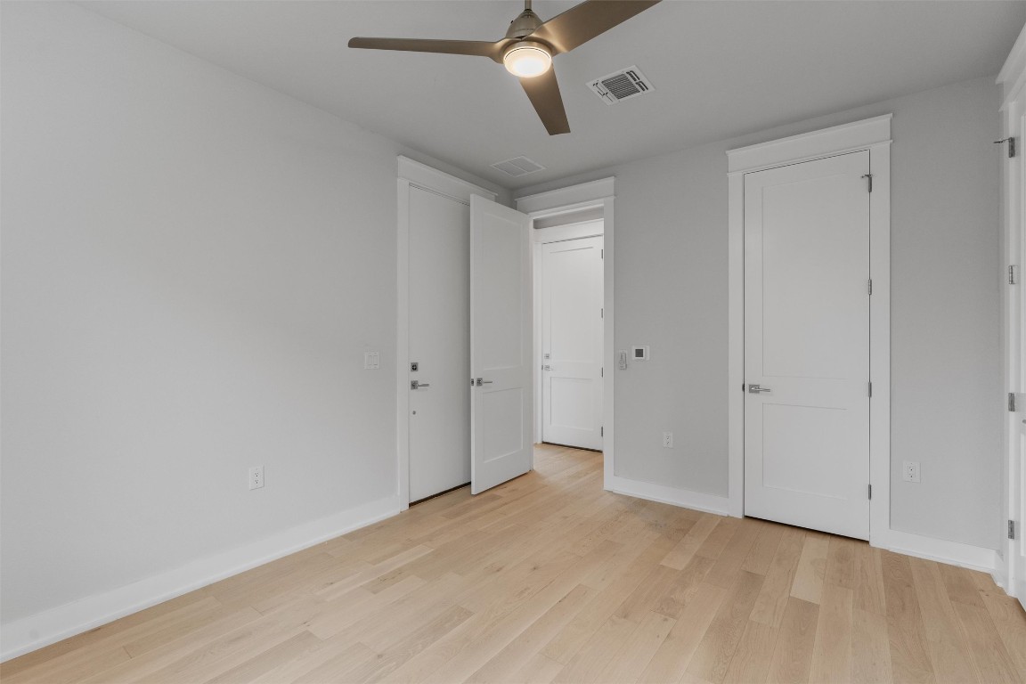 5002 Pecan Springs Road, Unit 1 Austin, TX 78723 - Photo 7 of 38 Unfurnished bedroom with light wood-type flooring and ceiling fan