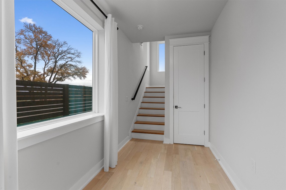 5002 Pecan Springs Road, Unit 1 Austin, TX 78723 - Photo 10 of 38 Stairs with wood finished floors and baseboards