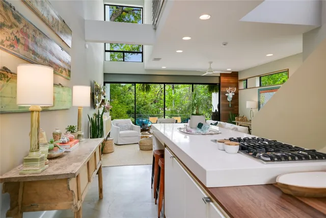 a room with a large window and dining table