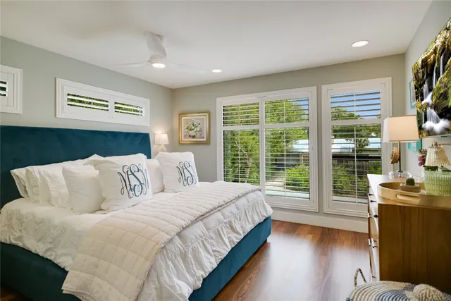 a bedroom with a large bed and a large window