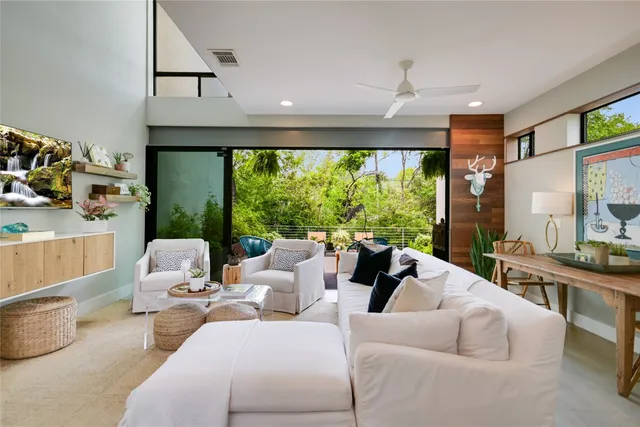 a living room with furniture and large windows