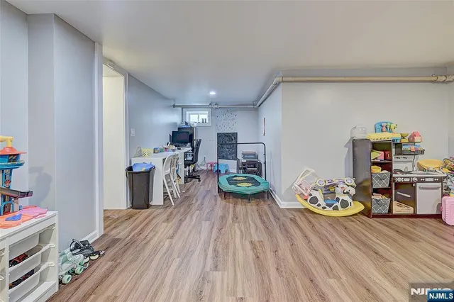 a bedroom with furniture and a wooden floor