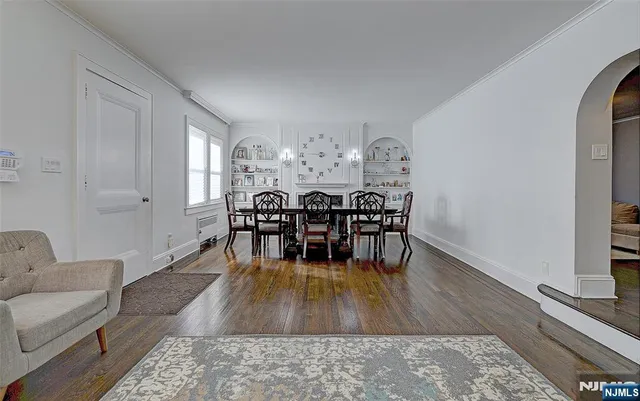 a living room with furniture dining table and a wooden floor