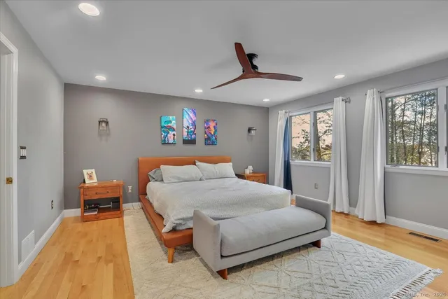 a bedroom with a large bed and a chandelier