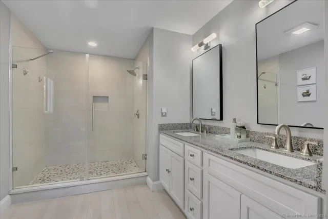 a bathroom with a granite countertop sink mirror and double