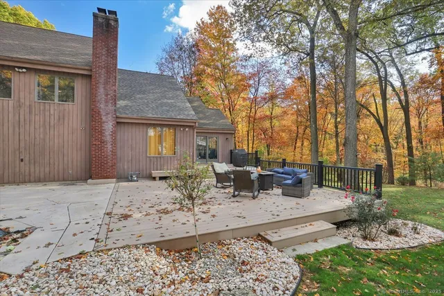 a view of backyard with outdoor seating and trees