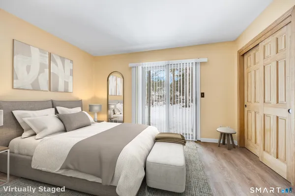 a bedroom with a bed and a large window