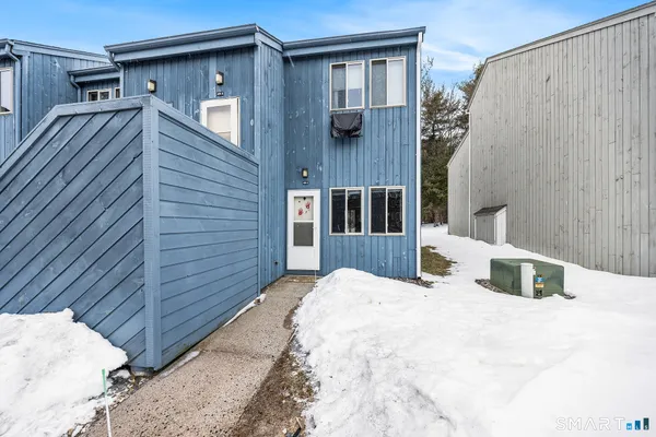 a view of small house with a backyard
