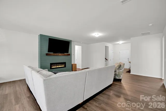 a living room with couches and a flat screen tv