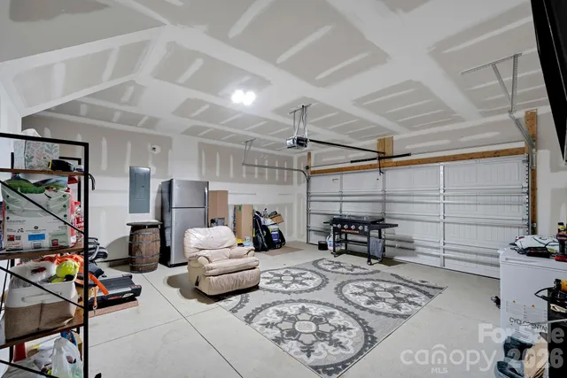 a living room with furniture a flat screen tv and a table