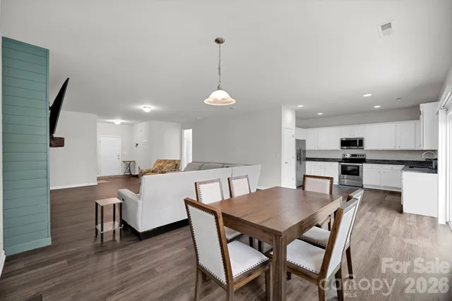 a dining room with furniture and wooden floor