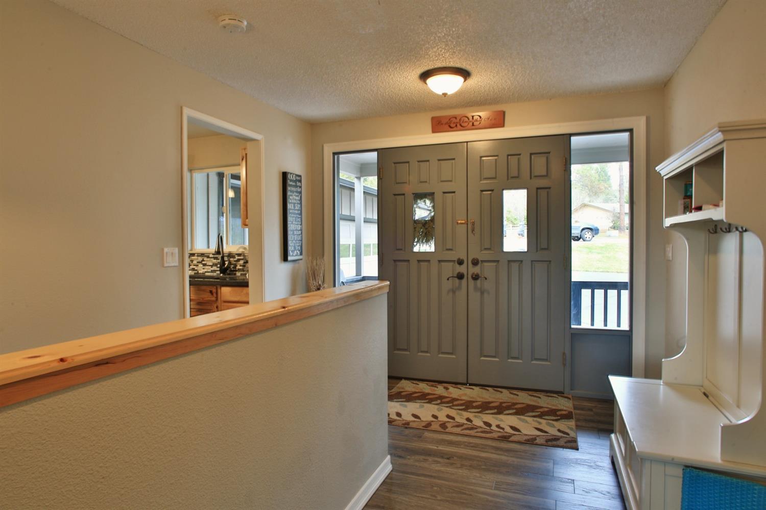 357 October Lane Merlin, OR 97532 - Photo 8 of 33 a view of a hallway with furniture and wooden floor