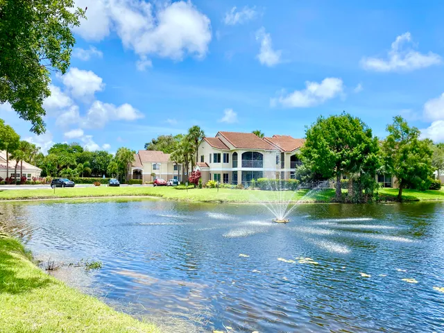 a view of swimming pool in front of house with yard and outdoor seating
