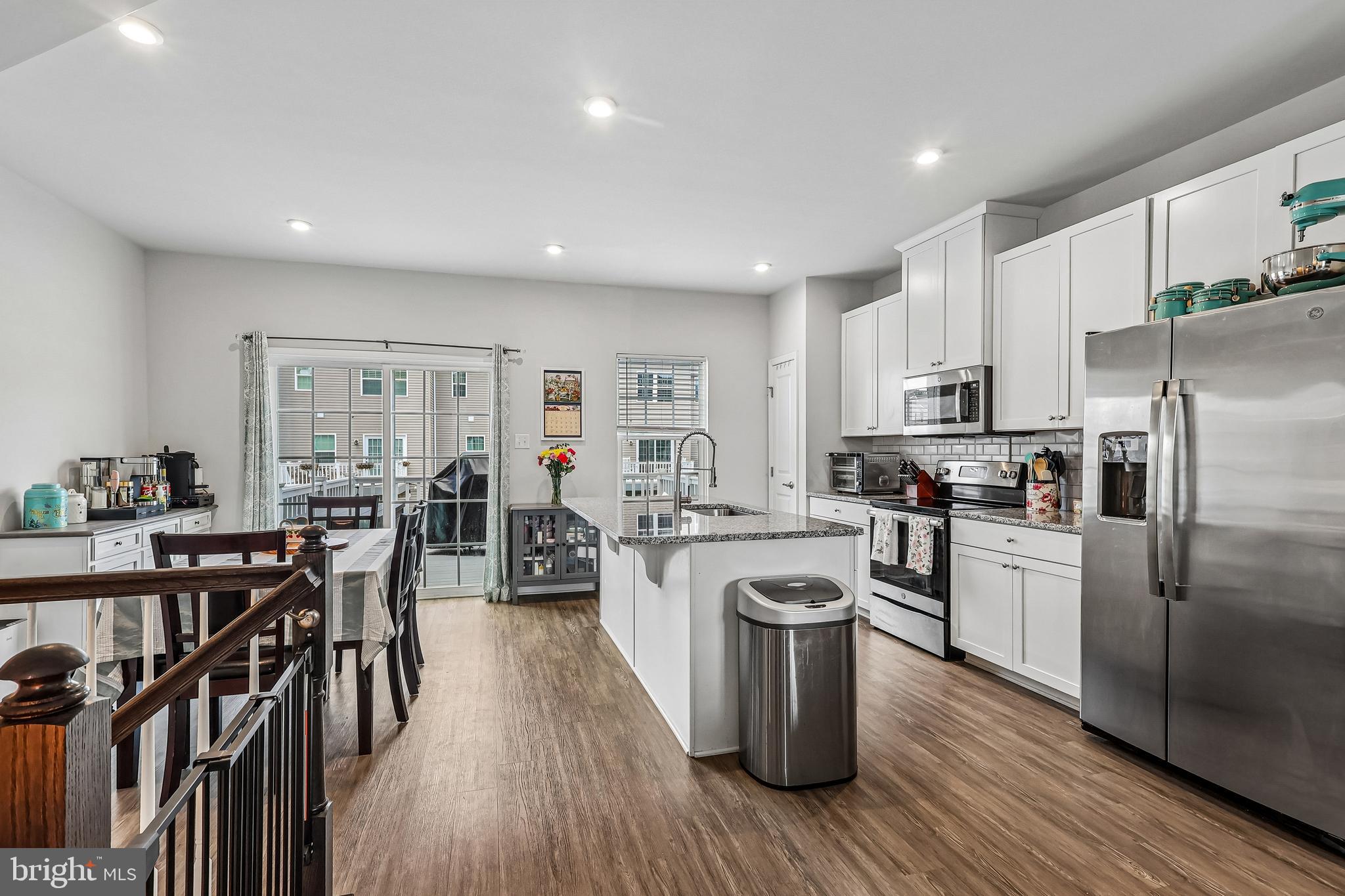 138 Pinnacle Place Sewell, NJ 08080 - Photo 5 of 52 a kitchen with cabinets wooden floor and stainless steel appliances