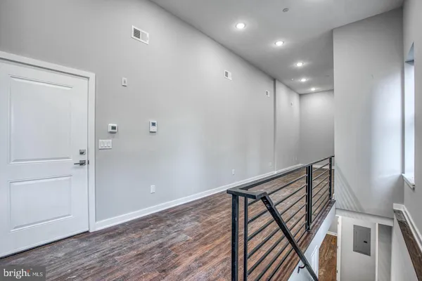 a view of a room with wooden floor