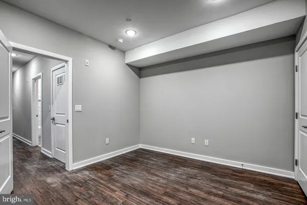a bathroom with a toilet sink vanity and shower
