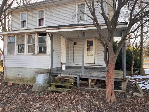a backyard of a house with table and chairs