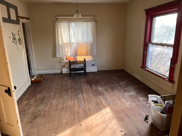 a view of a livingroom with furniture hardwood floor and a window