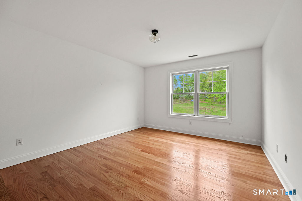 8 Ridgewood Club Road Prospect, CT 06712 - Photo 22 of 40 a view of an empty room with wooden floor and a window