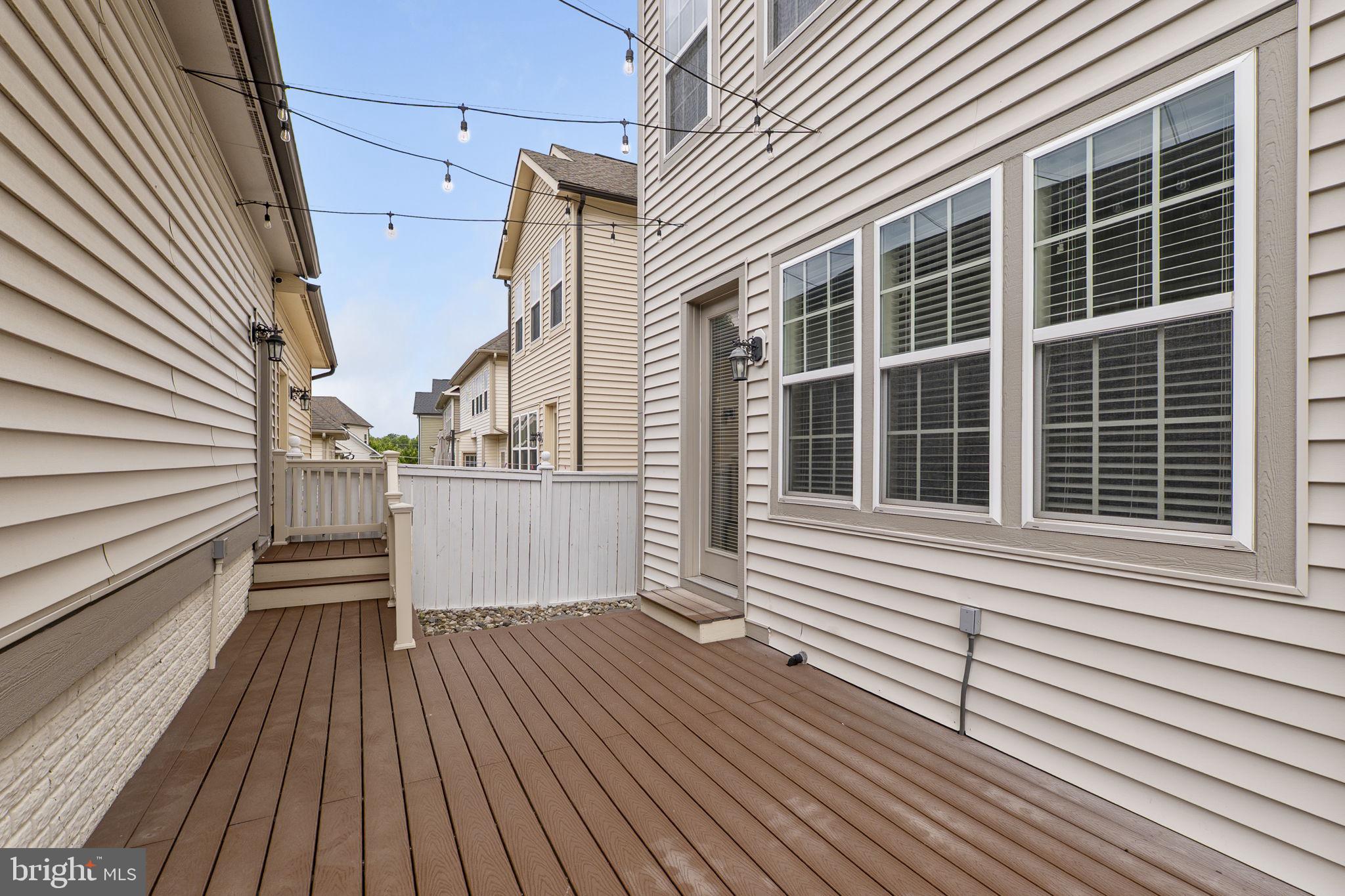 23902 Grapevine Ridge Terrace Clarksburg, MD 20871 - Photo 34 of 44 a view of a balcony with wooden floor and fence and a window