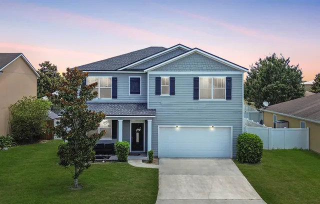 a front view of a house with garden