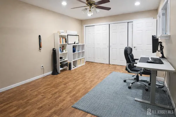 a bedroom with a bed a chandelier and a window