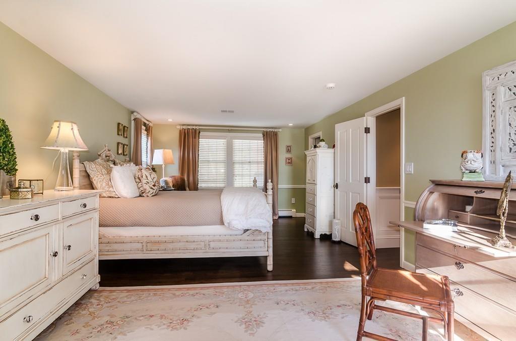41 Highgate Road Wellesley, MA 02481 - Photo 16 of 24 a spacious bedroom with a bed a mirror and a dresser in it