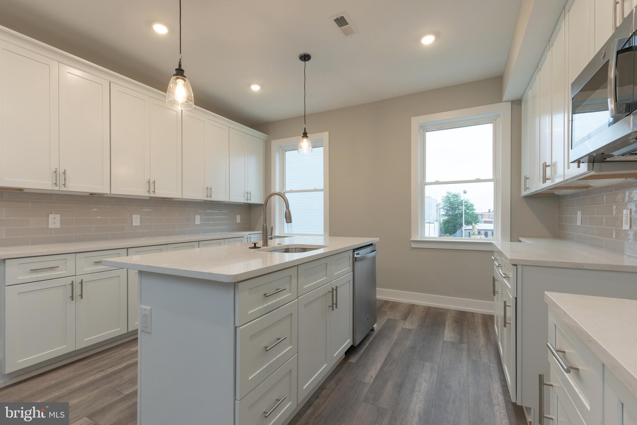 135 West Huntingdon Street, Unit 2 Philadelphia, PA 19133 - Photo 3 of 29 a kitchen with a sink stove and cabinets