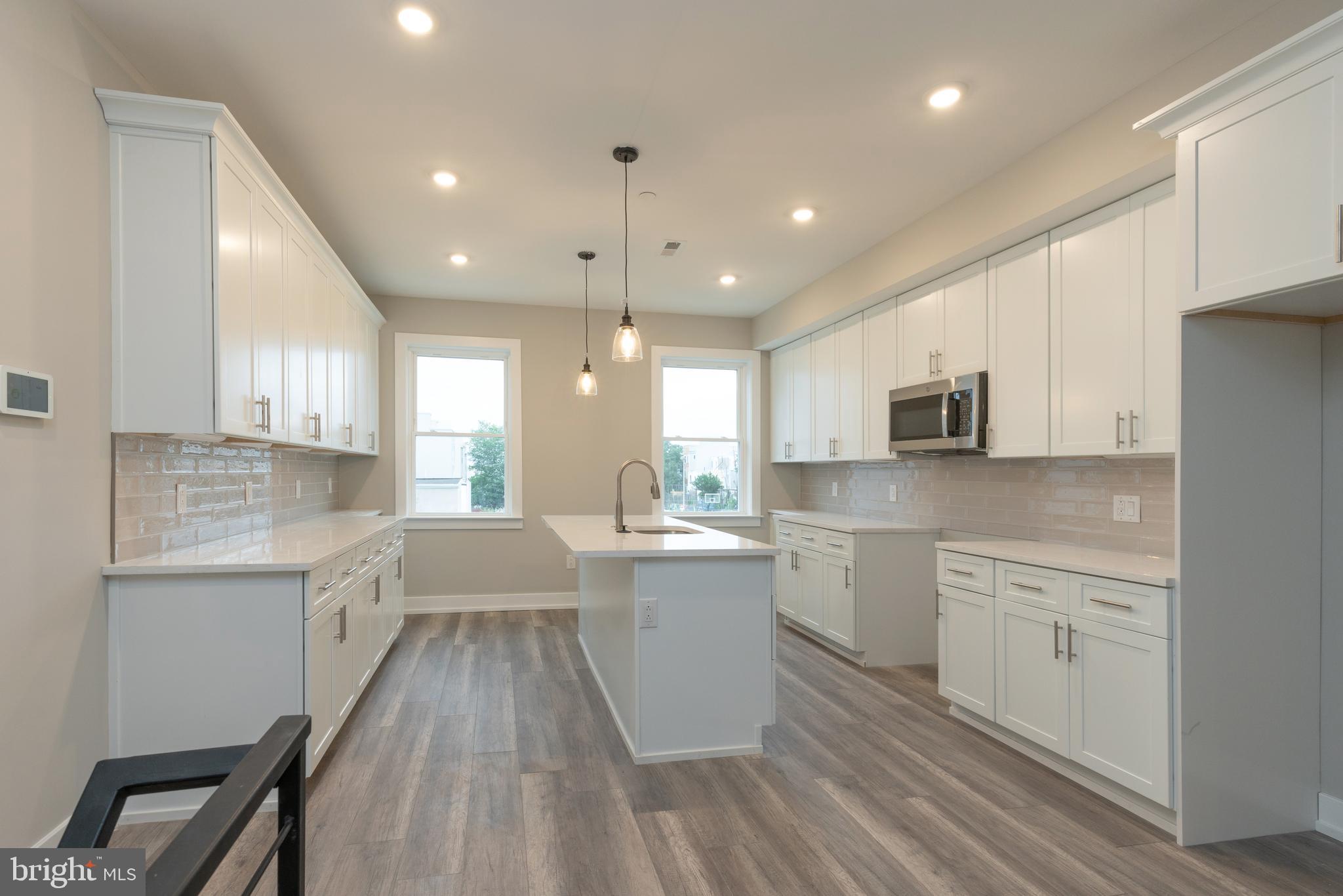 135 West Huntingdon Street, Unit 2 Philadelphia, PA 19133 - Photo 6 of 29 a large kitchen with a lot of counter space and a sink