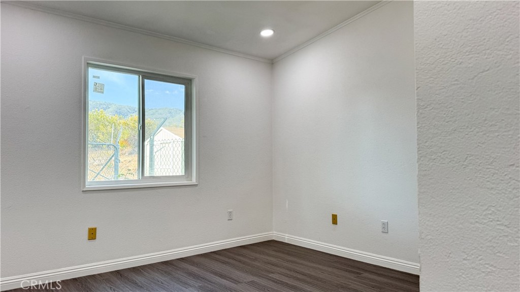 56515 Dickson Way Anza, CA 92539 - Photo 16 of 17 an empty room with wooden floor and windows