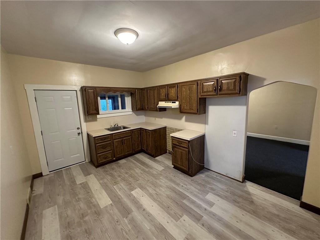 615 Division Street Monessen, PA 15062 - Photo 4 of 15 a kitchen with stainless steel appliances a sink and a refrigerator