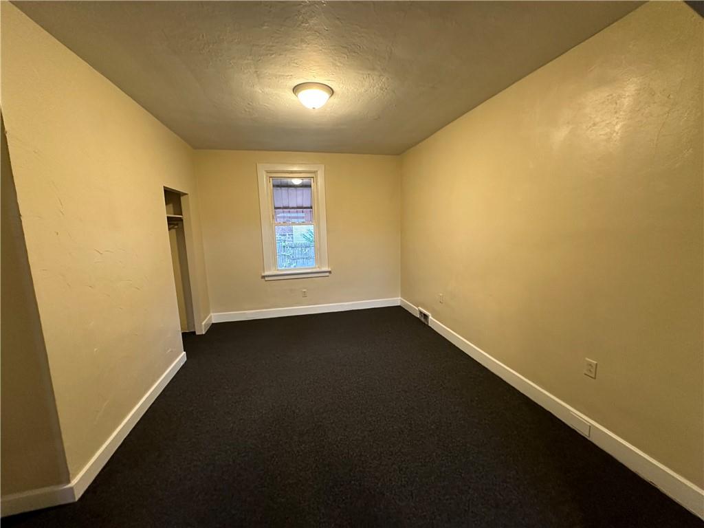 615 Division Street Monessen, PA 15062 - Photo 8 of 15 an empty room with a empty space and a window