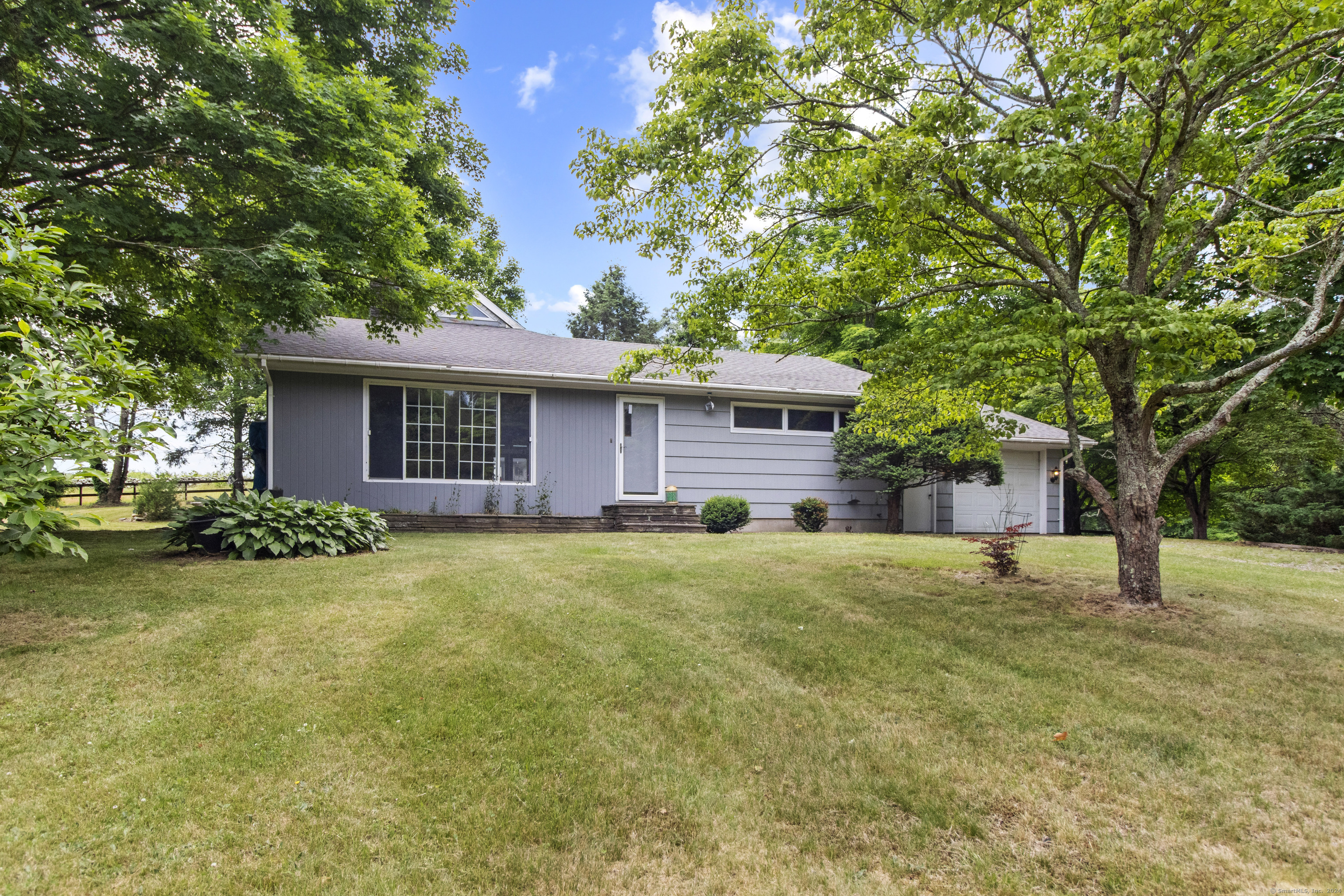 a front view of a house with a garden
