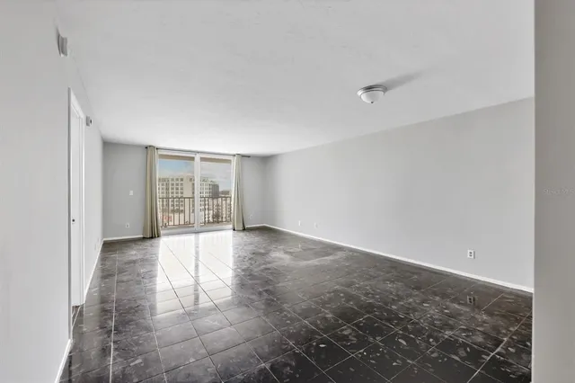 a view of an empty room with a window