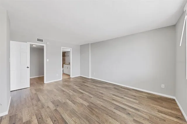 a view of walk in closet with empty racks