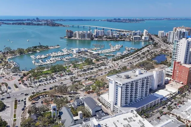a view of a lake with a yard and large trees
