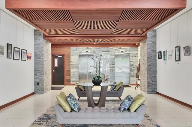 a living room with furniture and a potted plant