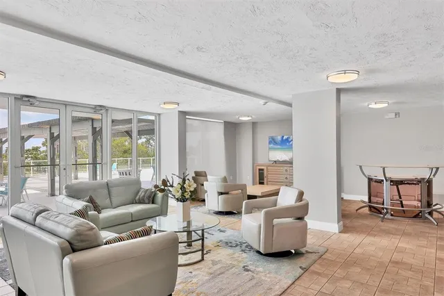 a dining room with furniture and floor to ceiling windows