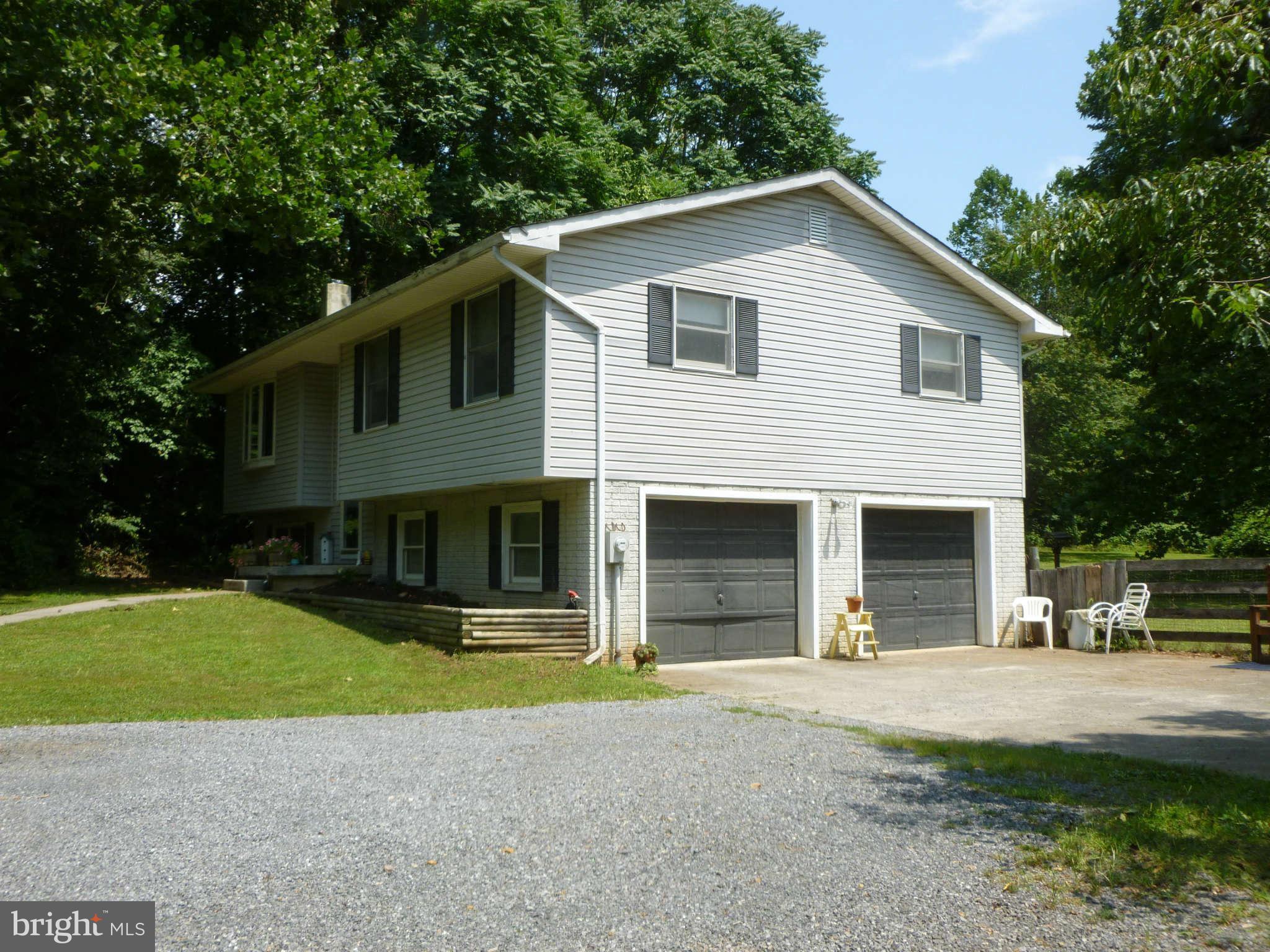 5762 Howellsville Road Front Royal, VA 22630 - Photo 3 of 22 a front view of a house with a yard and garage