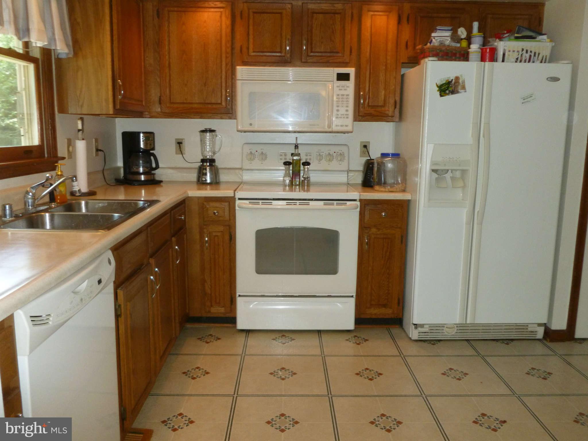 5762 Howellsville Road Front Royal, VA 22630 - Photo 9 of 22 a kitchen with stainless steel appliances a stove a sink and a refrigerator