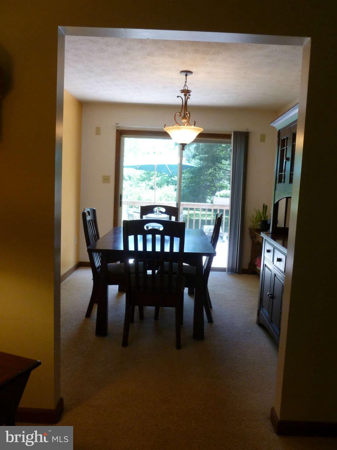 5762 Howellsville Road Front Royal, VA 22630 - Photo 10 of 22 a dining room with furniture a rug and a floor to ceiling window