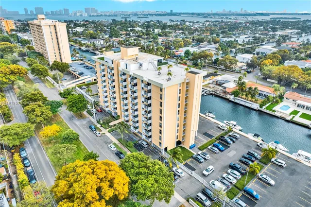 an aerial view of residential building and lake