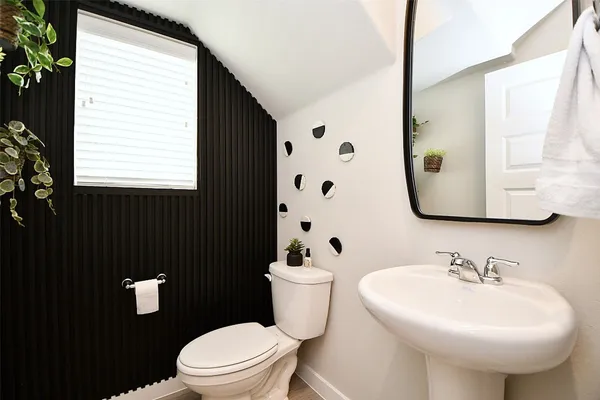 a bathroom with a sink a mirror and a toilet