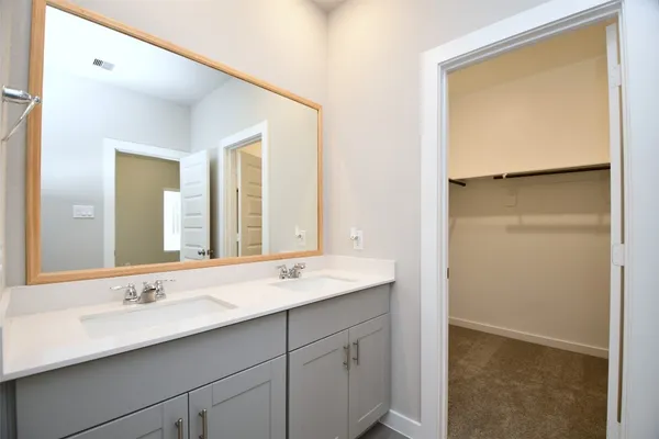 a bathroom with a double vanity sink and a mirror