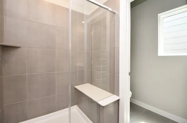a bathroom with a shower and a sink