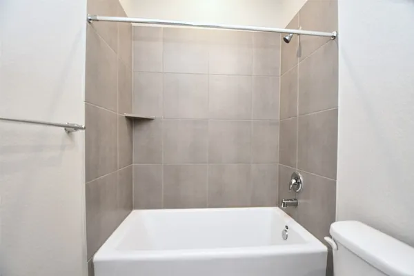 a bathroom with a white bath tub and a shower in it